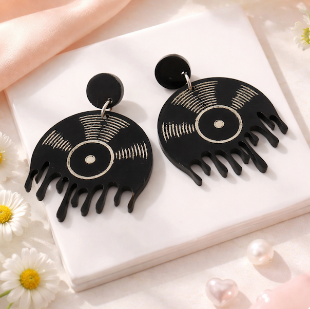 Handmade melting vinyl record statement earrings in black acrylic on neutral background