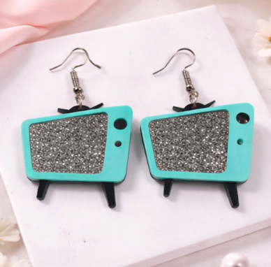 Retro TV acrylic earrings with glitter screen in Teal on a neutral background