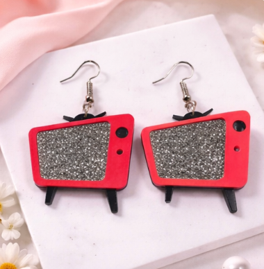 Retro TV acrylic earrings with glitter screen in Hot Pink on a neutral background