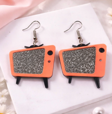 Retro TV acrylic earrings with glitter screen in Pale Pink on a neutral background