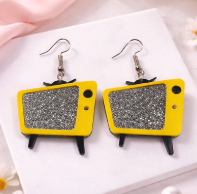 Retro TV acrylic earrings with glitter screen in Yelllow on a neutral background
