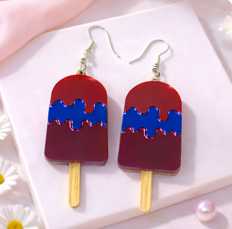 Red and blue popsicle-shaped acrylic earrings with silver hooks on a soft neutral background