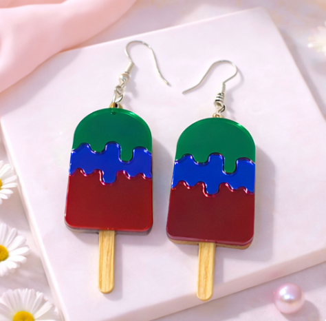 Red and purple popsicle-shaped acrylic earrings with silver hooks on a soft neutral background