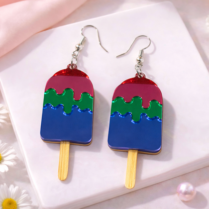 Red and purple popsicle-shaped acrylic earrings with silver hooks on a soft neutral background