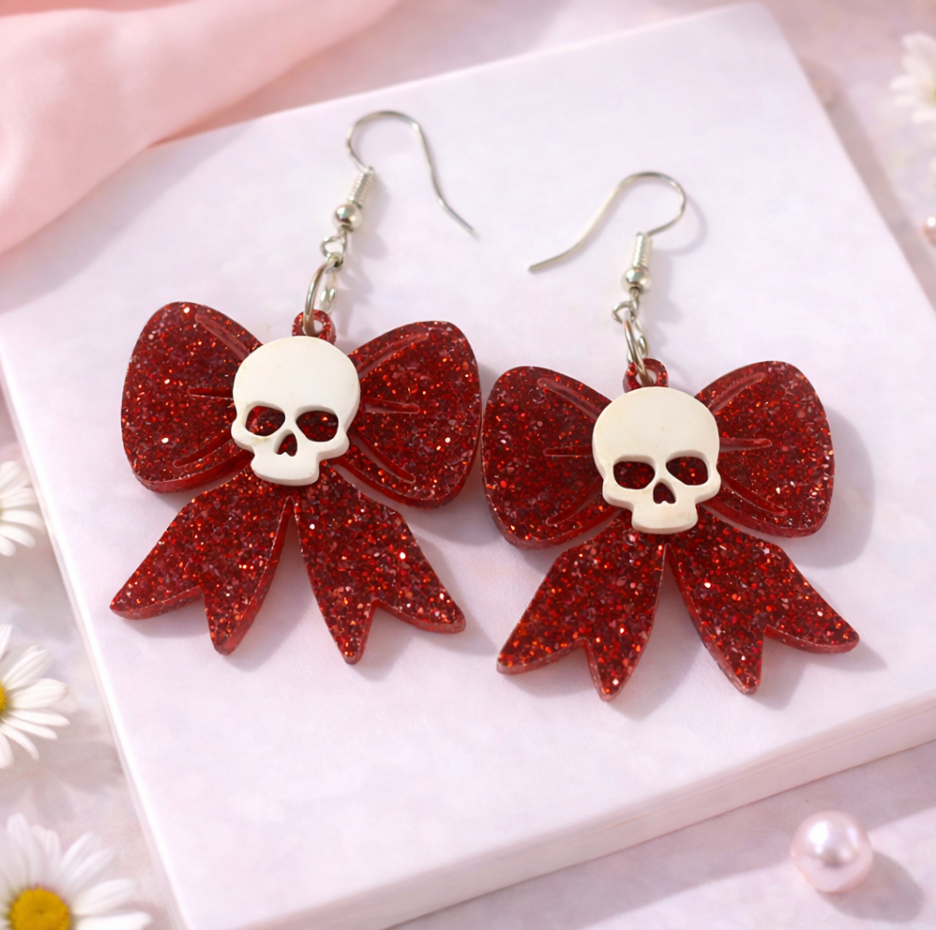 Red glitter skull bow earrings featuring skull detail, lightweight acrylic statement earrings