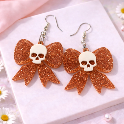 Rose Gold glitter skull bow earrings featuring skull detail, lightweight acrylic statement earrings